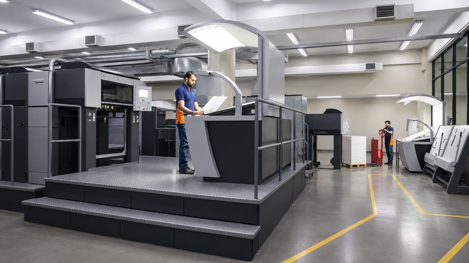 Operator at the console of a multi-colour offset press